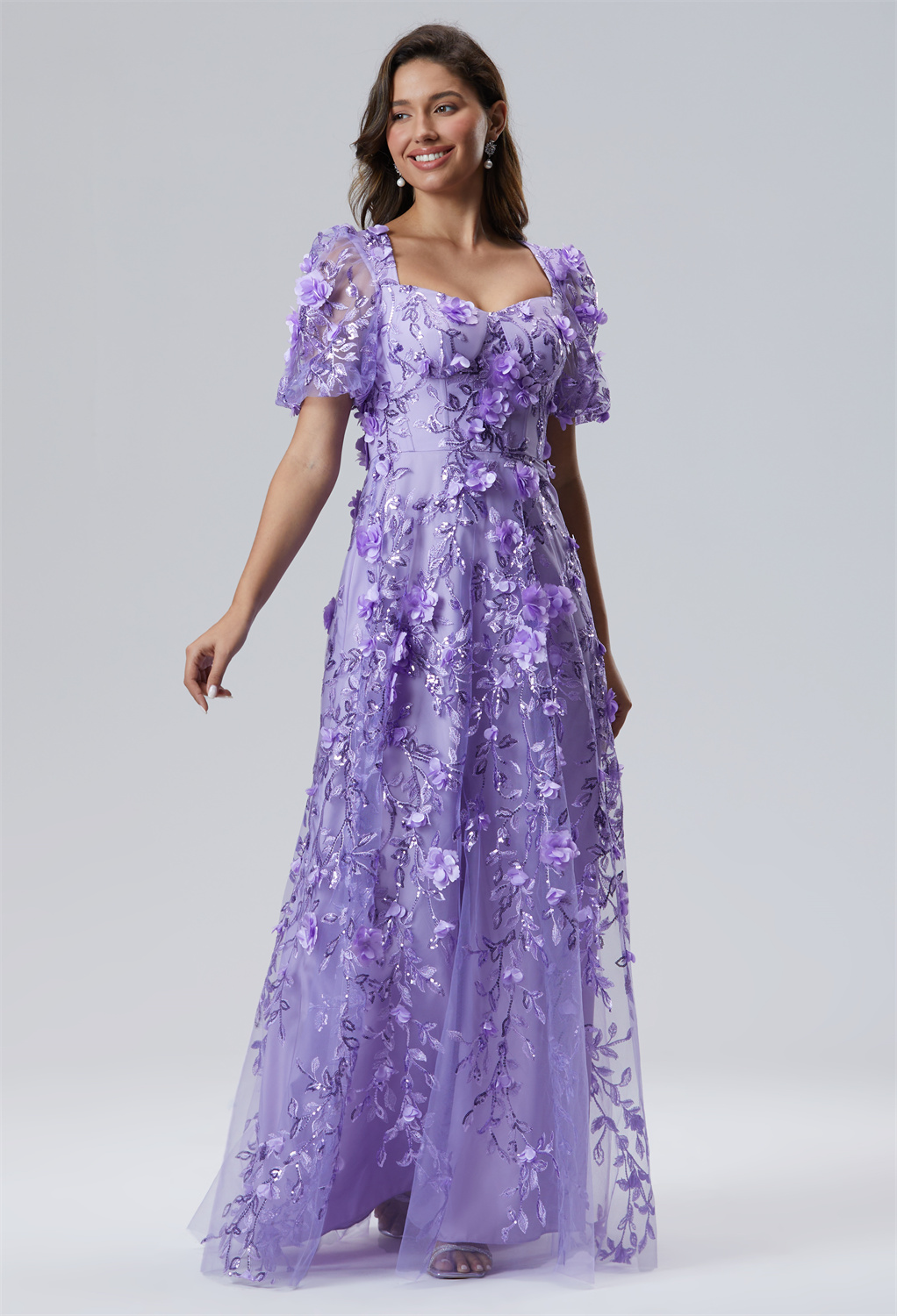 The short sleeves and strapless design of this floor-length A-line dress in tulle with a sweetheart neckline offer a chic blend of comfort and style.