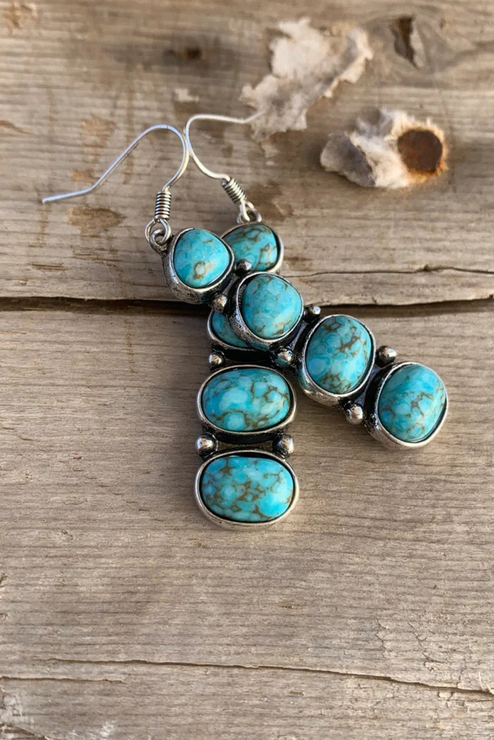 Add a splash of bold turquoise to your outfit with these stacked dangle earrings. Their eye-catching and one-of-a-kind design is perfect for any occasion