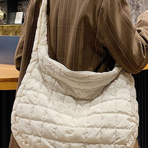 Add a touch of elegance to your look with the quilted design! This spacious tote (15x5x12 in) can easily hold all your essentials