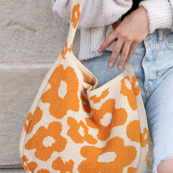 Add an elegant touch to your outfit with the stylish flower design. Ample space for all your essentials with dimensions of 14*4*21in. Crafted from high-quality knitted material for lasting durability. Easily carry with a single shoulder strap for comfort