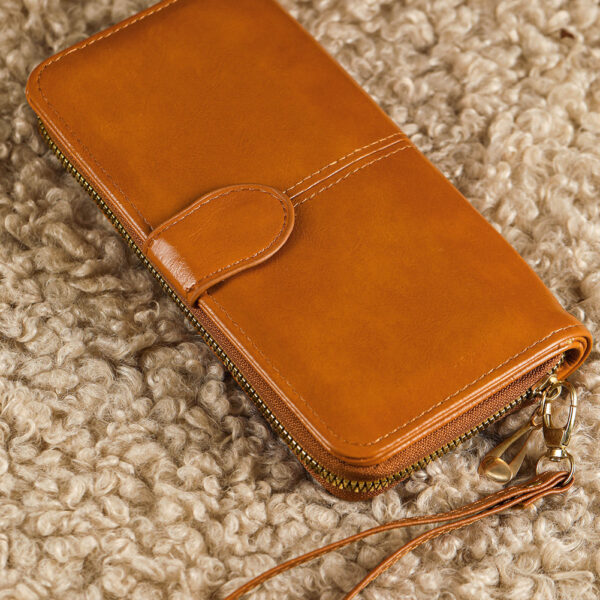 Get your hands on this chic wallet that combines both style and security with its zip-around design. The elongated shape offers plenty of room for your cards