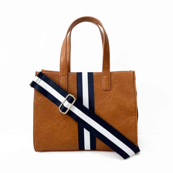 Our beautiful Becki tote from the Threaded Pear is the perfect take anywhere bag. The stunning vegan leather bag with accent stripe and matching shoulder strap features a zipper closure to access the spacious interior for all your must-have essentials.