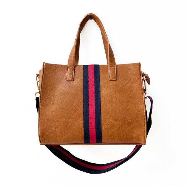 Our beautiful Becki tote from the Threaded Pear is the perfect take anywhere bag. The stunning vegan leather bag with accent stripe and matching shoulder strap features a zipper closure to access the spacious interior for all your must-have essentials.