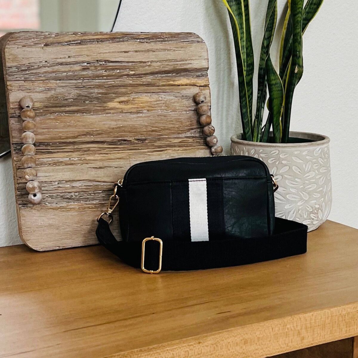 Our beautiful and soft Ava vegan leather Crossbody from the Threaded Pear is the perfect take anywhere bag. This stunning bag features a decorative front stripe and is a compact design with gold hardware top zipper for all your must-have essentials and