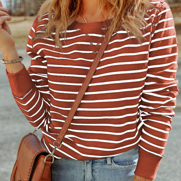 Elevate your style with this trendy long sleeve top featuring a timeless striped print and playful ribbed accents at the cuffs