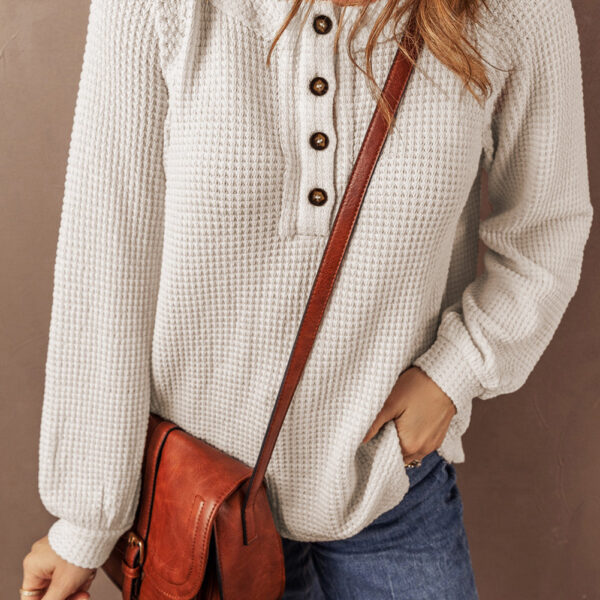 This cozy and textured waffle top features a stylish button placket for easy wear and a chic look