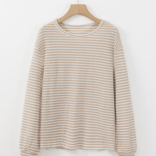 Get ready to rock a top that's effortlessly chic - this women's top features a classic striped pattern that's sure to make a statement. With a relaxed drop shoulder design and a comfortable round neck