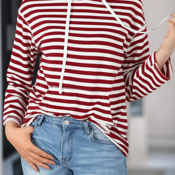 Stay trendy all year long with this Julia Stripe Kangaroo Pocket Drawstring Hoodie. Its classic striped print never goes out of style