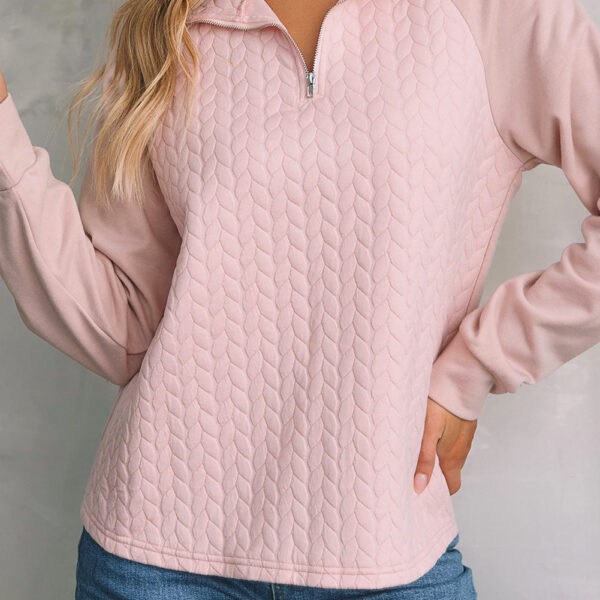 This timeless sweatshirt showcases a textured design and raglan sleeves for fashion-forward appeal. A turn-down collar with quarter zip ensures versatility to wear with jeans or shorts for effortless