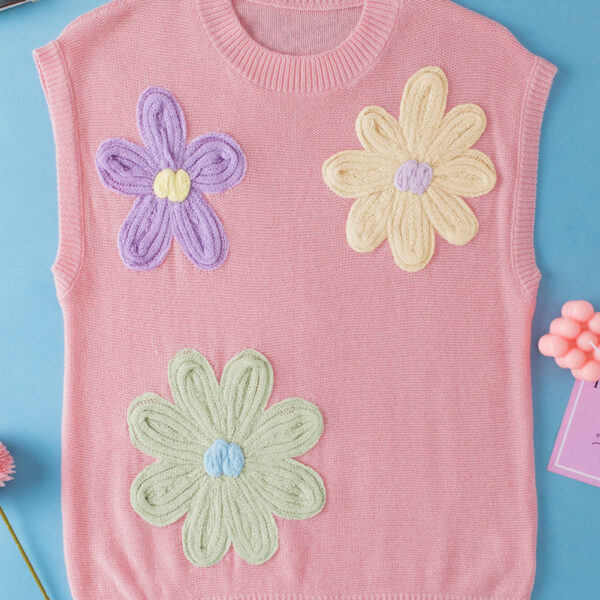 This top is adorned with delightful handmade crochet flowers
