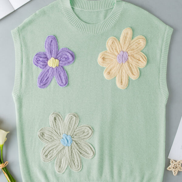 This top is adorned with delightful handmade crochet flowers