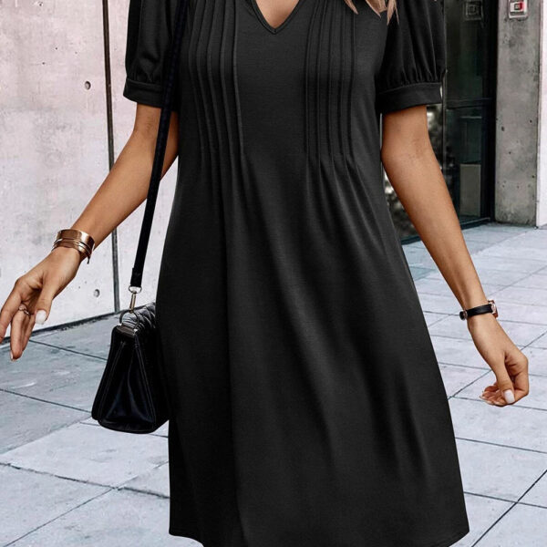 Get ready to turn heads in this one-of-a-kind shift dress with its pleated pizzazz and eye-catching notched neckline. The soft fabric and comfy shift style make it a fan favorite for any occasion.