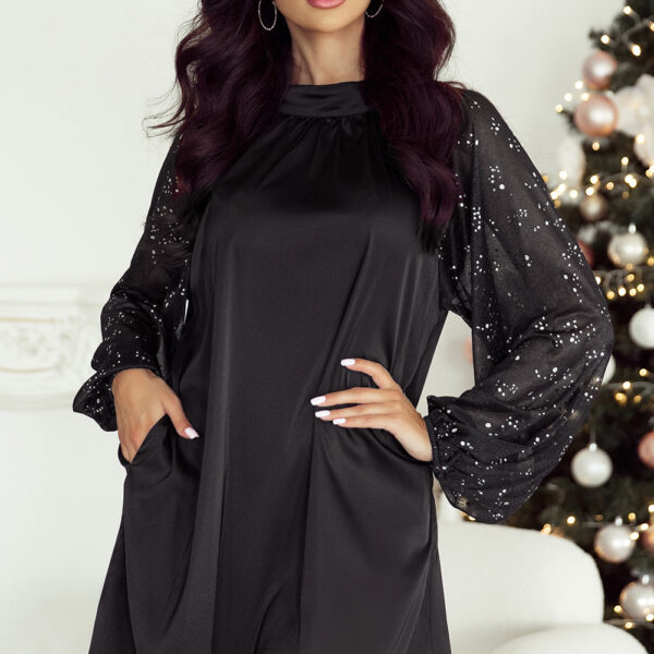 Make a stylish entrance with this dazzling mini dress. Featuring a mock neck for a touch of elegance and glittering mesh sleeves for a hint of sparkle