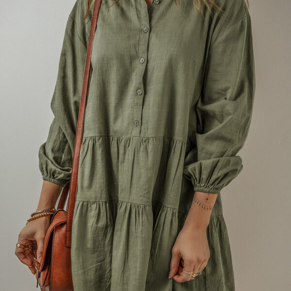 This mini dress has a sophisticated shirt style and fun puffy sleeves. Its buttoned front gives it a timeless look with a twist of femininity. The playful tiered pleats add a flattering and stylish flow that's perfect for dressing up with heels or keeping