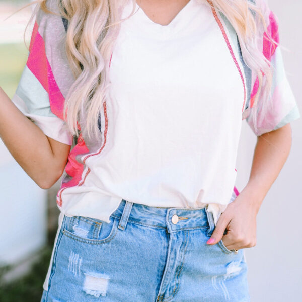 The Marie Patchwork Tee is a playful and quirky choice for adding some humor to your wardrobe. Its horizontal stripes of different colors and widths are stitched together in a unique design that is sure to catch attention. Made with a soft and comfy blend