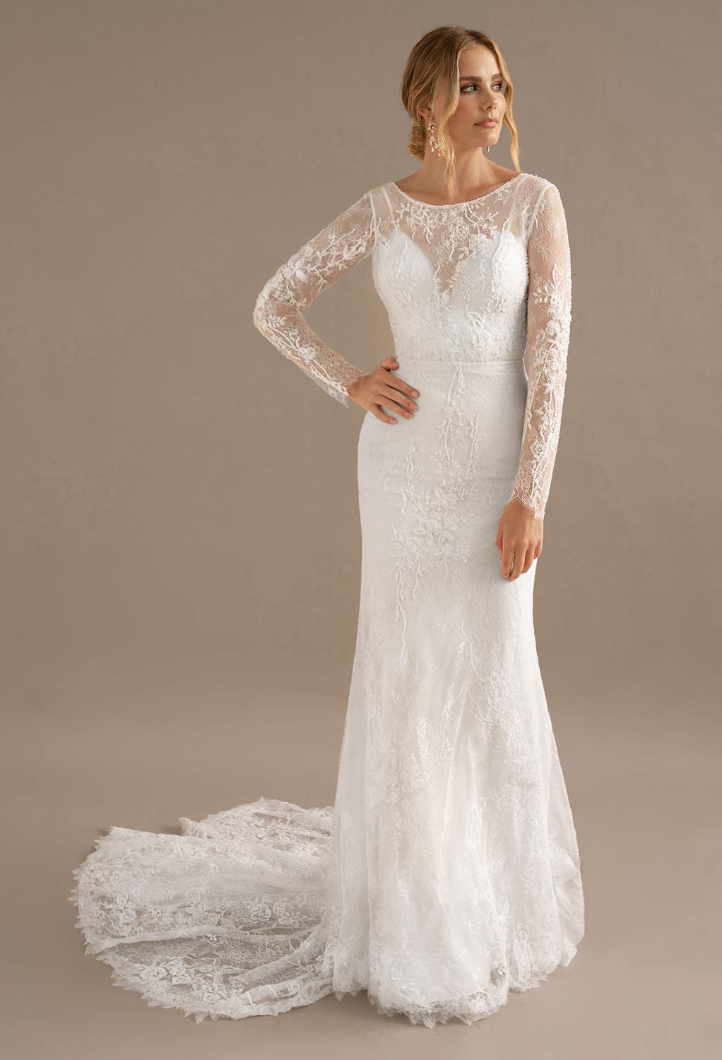 the Antonia wedding gown offers a combination sweetheart and bateau neckline. The long applique embellished sleeves are simply pretty touch. The neckline flatters and frames the brideu2019s beautiful face