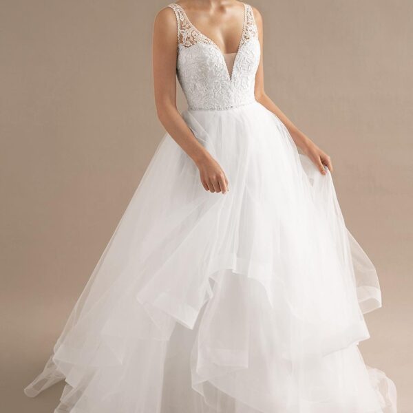 Flirty and playful layers of tulle come together in the Beverly wedding gown. Pleats and layers offer graceful and playful movement. The plunging neckline and bared back of the gown adds a delightfully romantic touch to the dress. The dress features elega