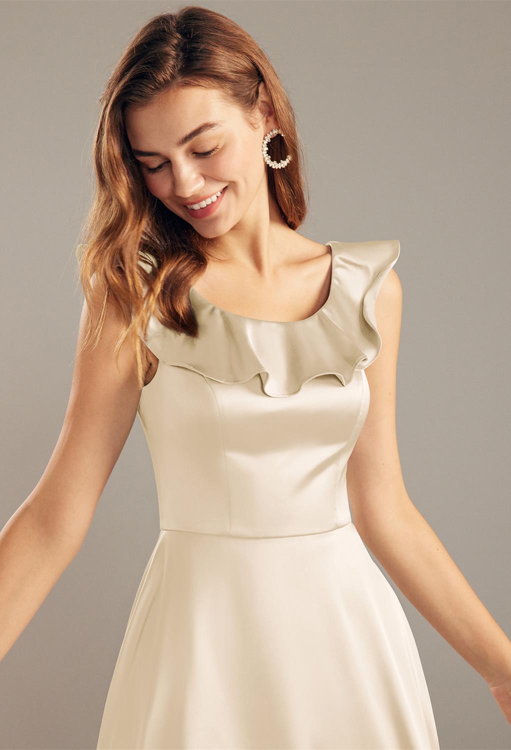 this A-line tea length dress croutline. Complemented with an elegant cape collar that sways to the back into