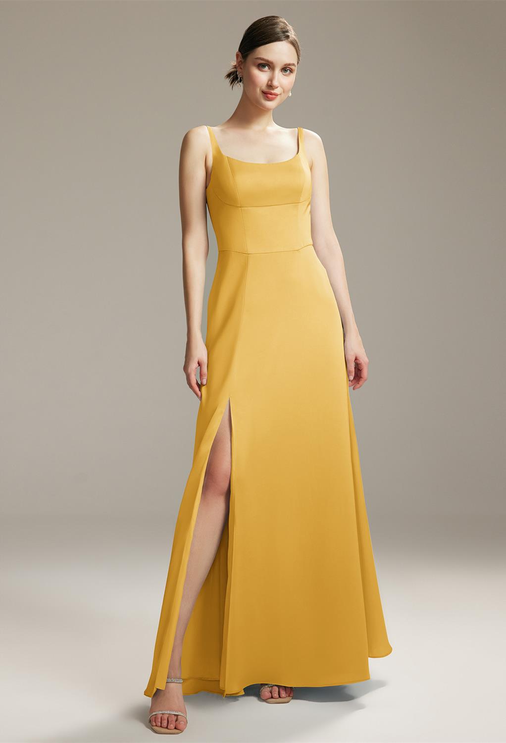 with a floor-length hemline for a graceful look. The scoop/U-neck neckline is adorned with sheer straps