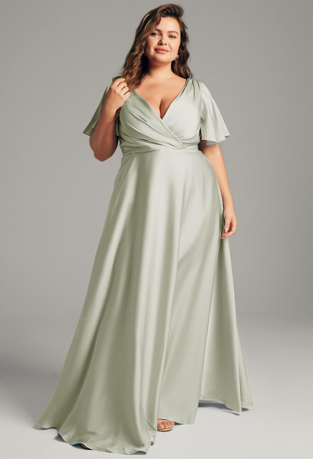 The AW Furst Dress is a sleek and simple bridesmaid dress available in over 29 colors. This unique V-neck silk gown is designed to flatter women of all sizes and is made from high-quality satin Charmeuse fabric with a unique pleat embellishment. It&#03