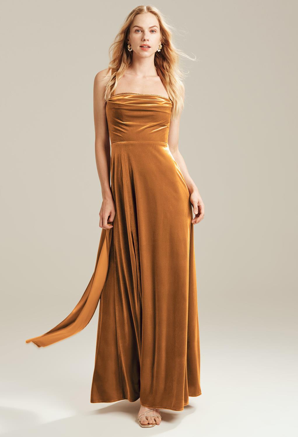 The Lally bridesmaid dress boasts a crisp velvet fabric that will give you the elegant look you want for a bridesmaid. The dress is a floor-length gown perfect for that traditional wedding. The straight neckline is flattering for ladies of all ages and bo