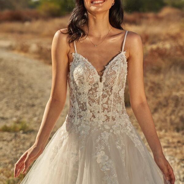 with the Lucia ball gown. The spaghetti straps come together with the plunging V-neck