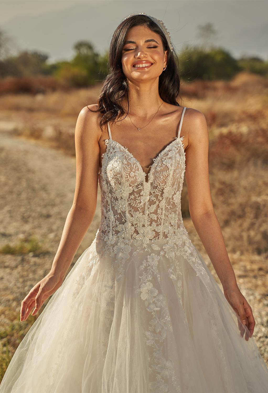 with the Lucia ball gown. The spaghetti straps come together with the plunging V-neck