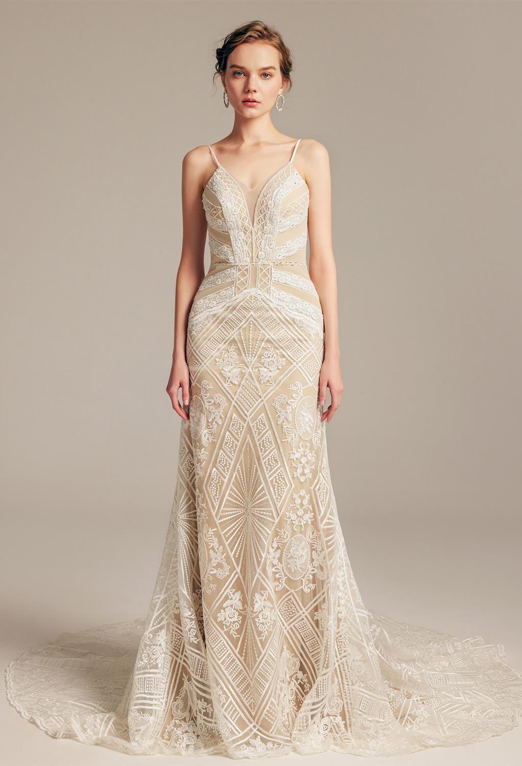 sleeveless dress with a mermaid outline flowing in a chapel train. It has a