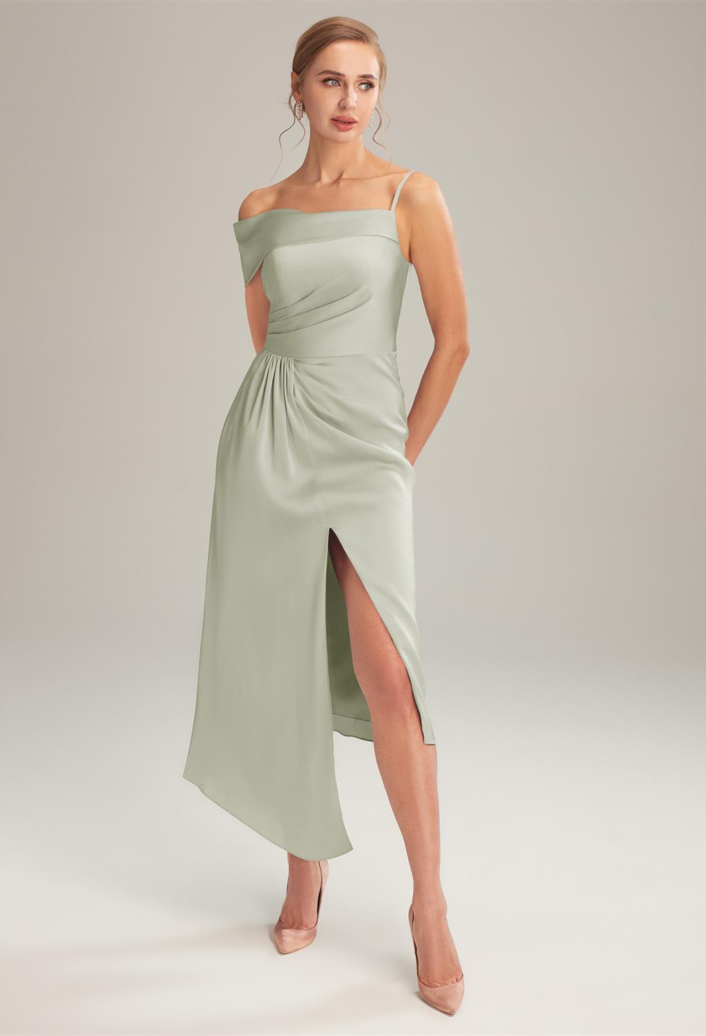 tea-length bridesmaid dress cut from satin charmeuse flaunts a bodice with a draped sleeve on one shoulder and spaghetti strap on the other shoulder. Topped with a ruched waistline and