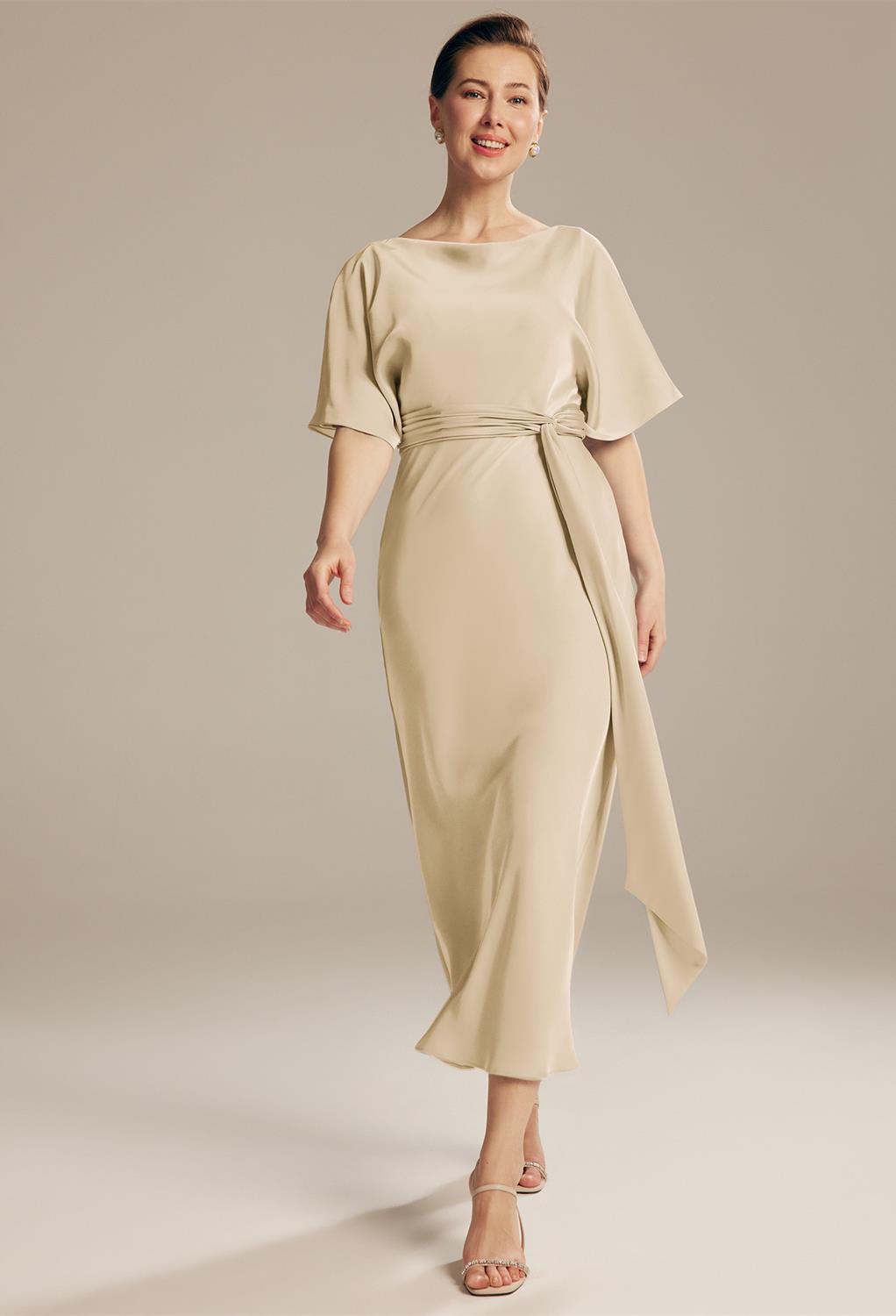 The AW Romula Dress is a glamorous-looking satin dress that embodies a clear touch of modern column silhouette vibes. This ankle-length dress is suitable for mothers of the brides and draws out a picture-perfect luxury while its elbow sleeves keep it simp