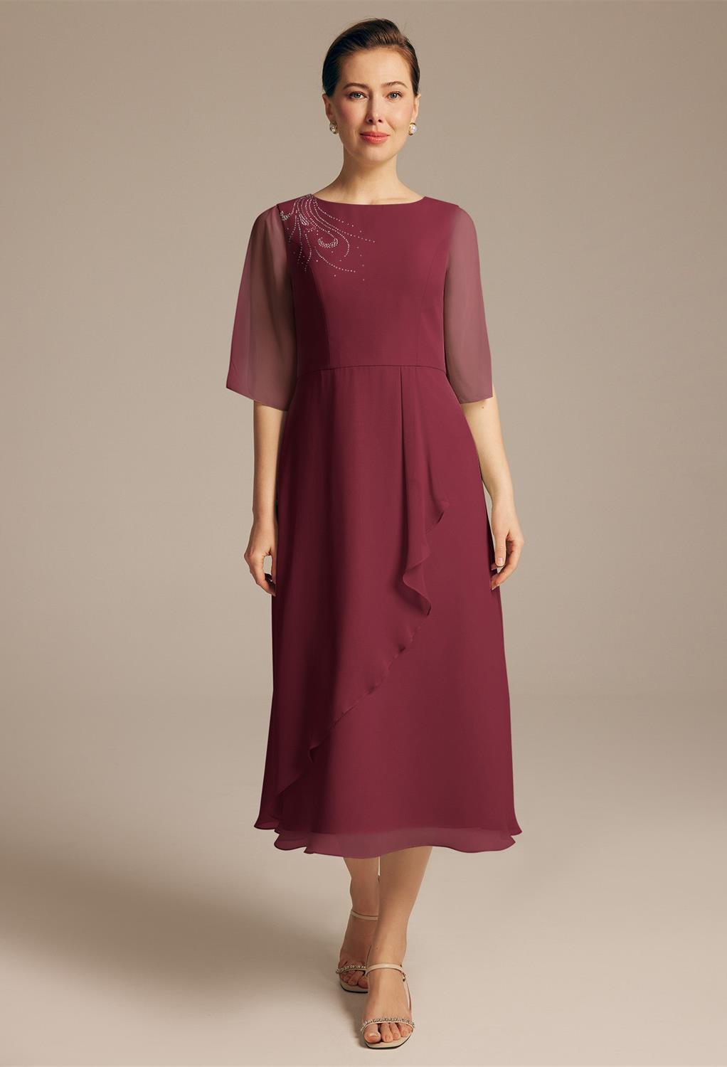 The AW Tanya Dress is a tea-length dress designed with quality chiffon fabric and styled with ruffles to make it stylishly simple. The dress features a jewel neckline with strapless elbow sleeves. The A-line body outline makes you look stunning at the eve