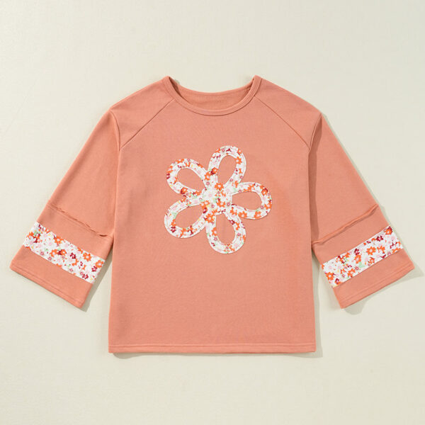 This flower graphic top boasts an unexpected and edgy exposed seam. Effortlessly chic with a relaxed and comfortable fit. Trendy and wide sleeves for a stylishly laid-back look. Enjoy a touch of unique and quirky with the beautiful flower design.
