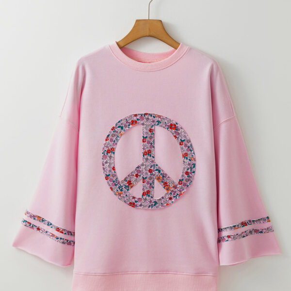 This breezy top seriously stands out with its floral peace sign graphic. The drop shoulder style adds a laid-back touch