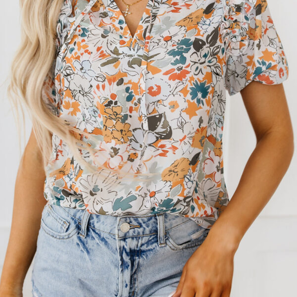 This blouse features a playful flower print for a pop of color