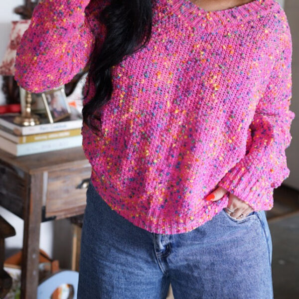 This knitted women's sweater boasts a spunky and lively pattern of bright spots. Made from a cozy and breathable knit